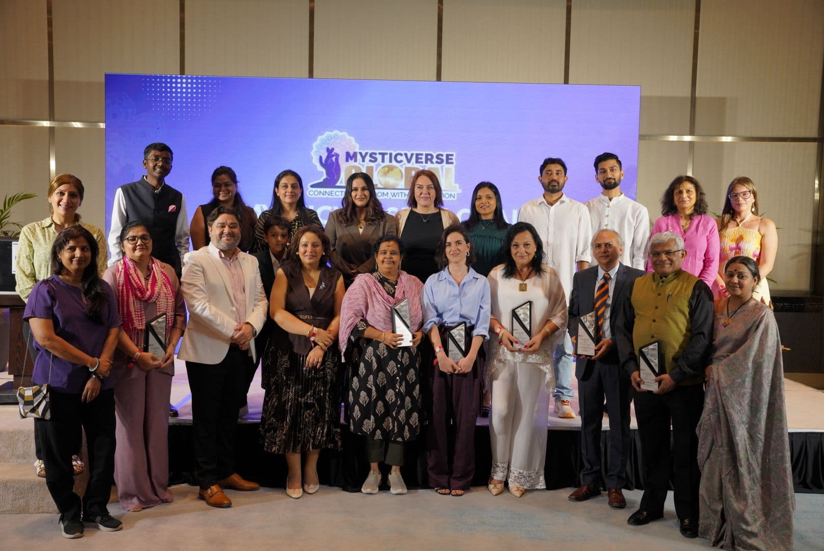 Speakers and honourees of MysticVerse Global 2026 on stage in Dubai, holding their awards