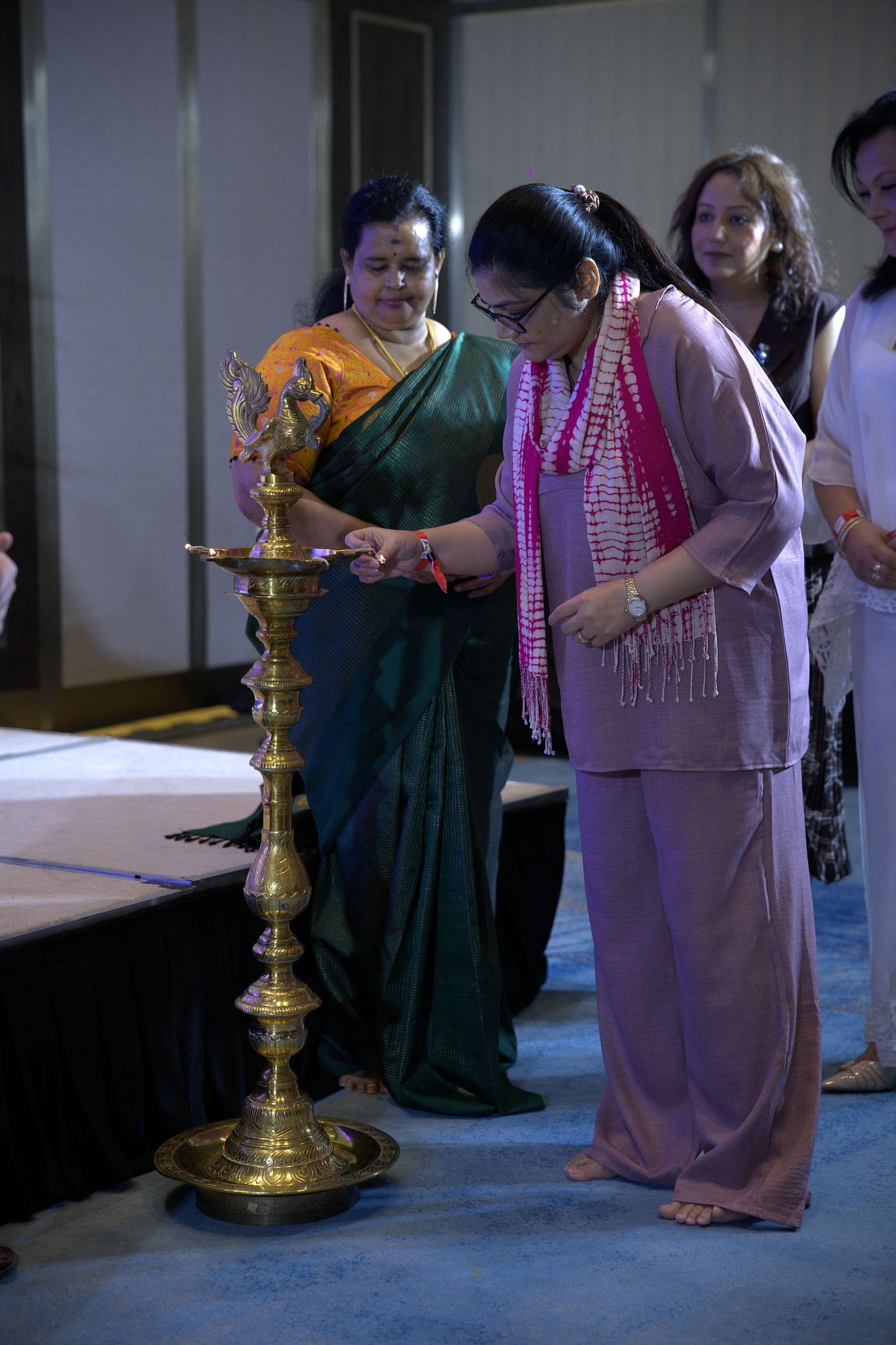 Guests lighting the ceremonial lamp at the start of the day
